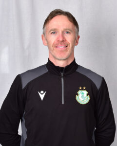 Portrait of Shamrock Rovers coach in team jacket with club crest.