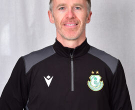 Portrait of Shamrock Rovers coach in team jacket with club crest.
