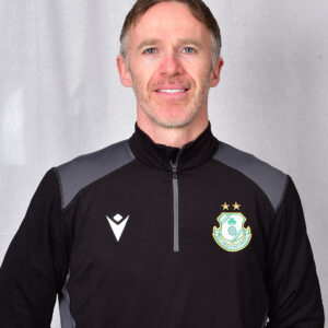 Portrait of Shamrock Rovers coach in team jacket with club crest.