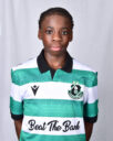 Young female football player in Shamrock Rovers kit, standing confidently.