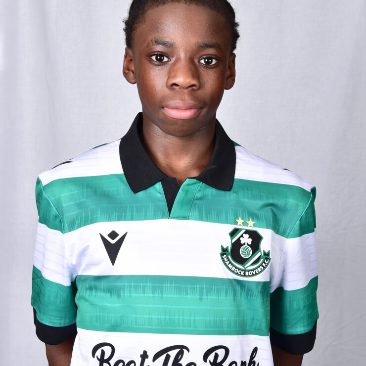 Young female football player in Shamrock Rovers kit, standing confidently.