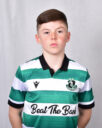 Young Shamrock Rovers player in green and white kit, standing confidently.