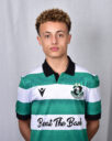 Young Shamrock Rovers player in green and white jersey, standing against a grey background.