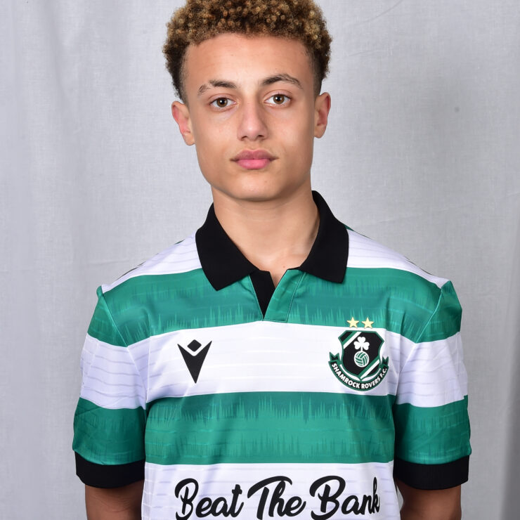 Young Shamrock Rovers player in green and white jersey, standing against a grey background.