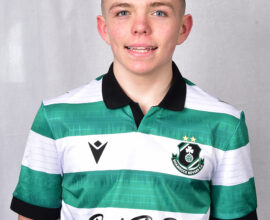 Shamrock Rovers football player in green and white striped jersey.