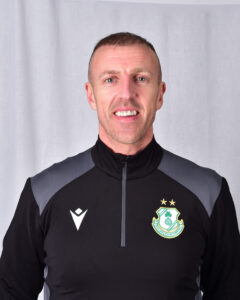 Shamrock Rovers player in team kit with club crest and stars.