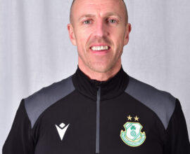 Shamrock Rovers player in team kit with club crest and stars.