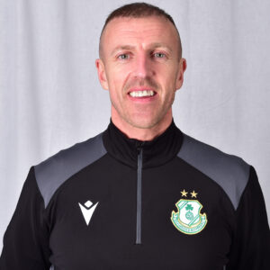 Shamrock Rovers player in team kit with club crest and stars.