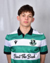 Young Shamrock Rovers player in green and white jersey, standing against a grey background.