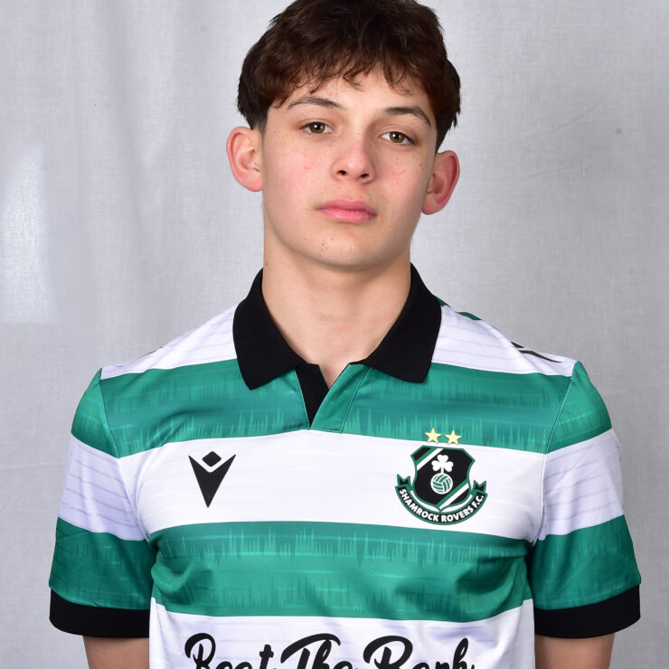 Young Shamrock Rovers player in green and white jersey, standing against a grey background.