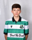 Young Shamrock Rovers player in green and white jersey, standing against a grey background.