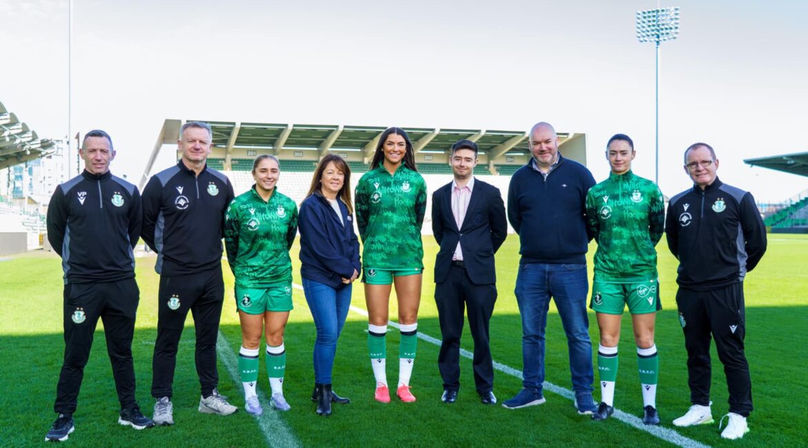 Shamrock Rovers players and staff with Tallaght & Firhouse Credit Union representatives on the pitch.