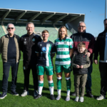 Shamrock Rovers players with fans on the pitch at Tallaght Stadium, Dublin.