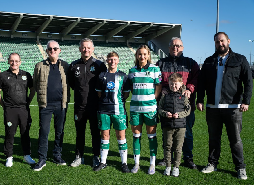 Shamrock Rovers players with fans on the pitch at Tallaght Stadium, Dublin.