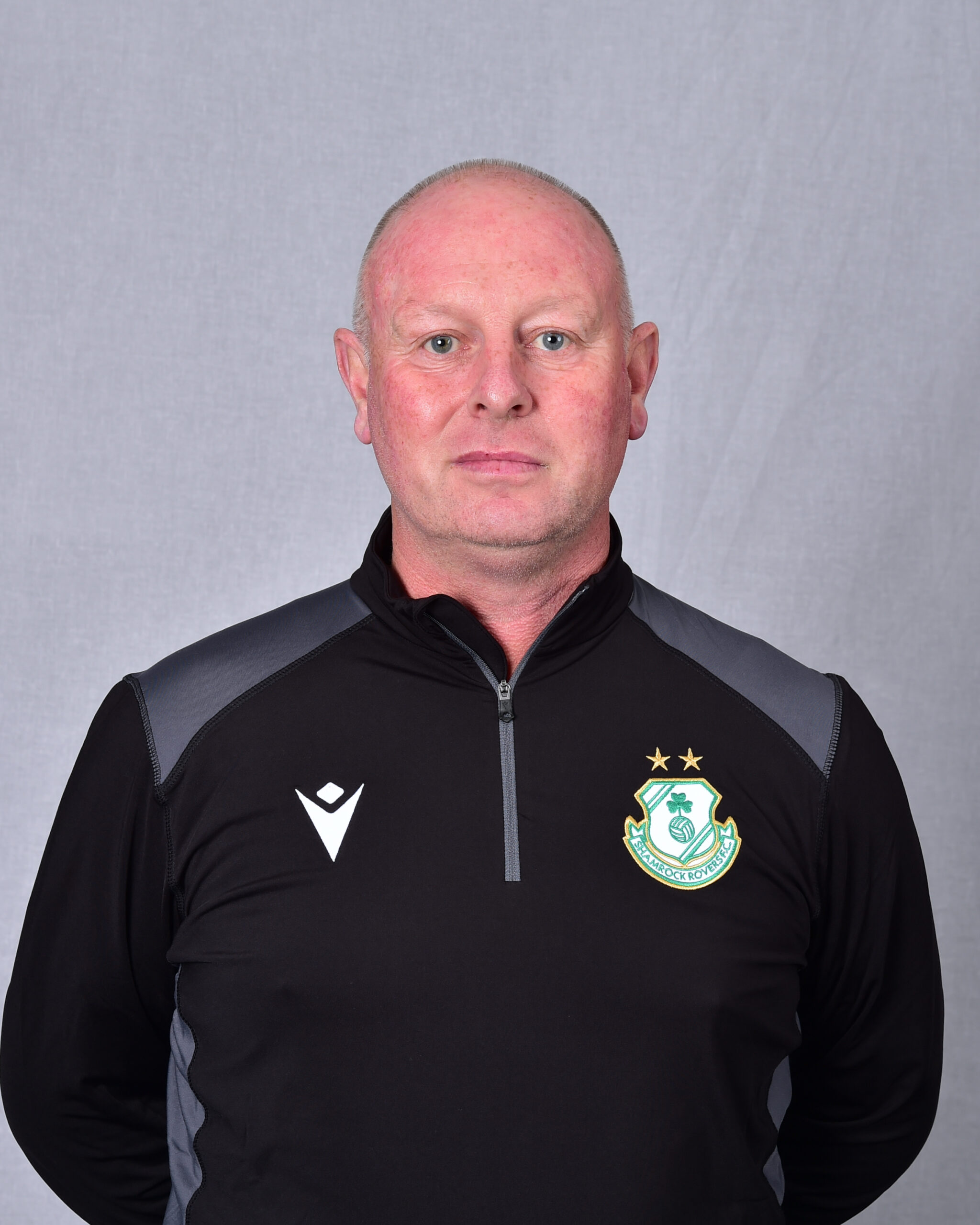 Shamrock Rovers coach in team jacket with club crest, facing camera.