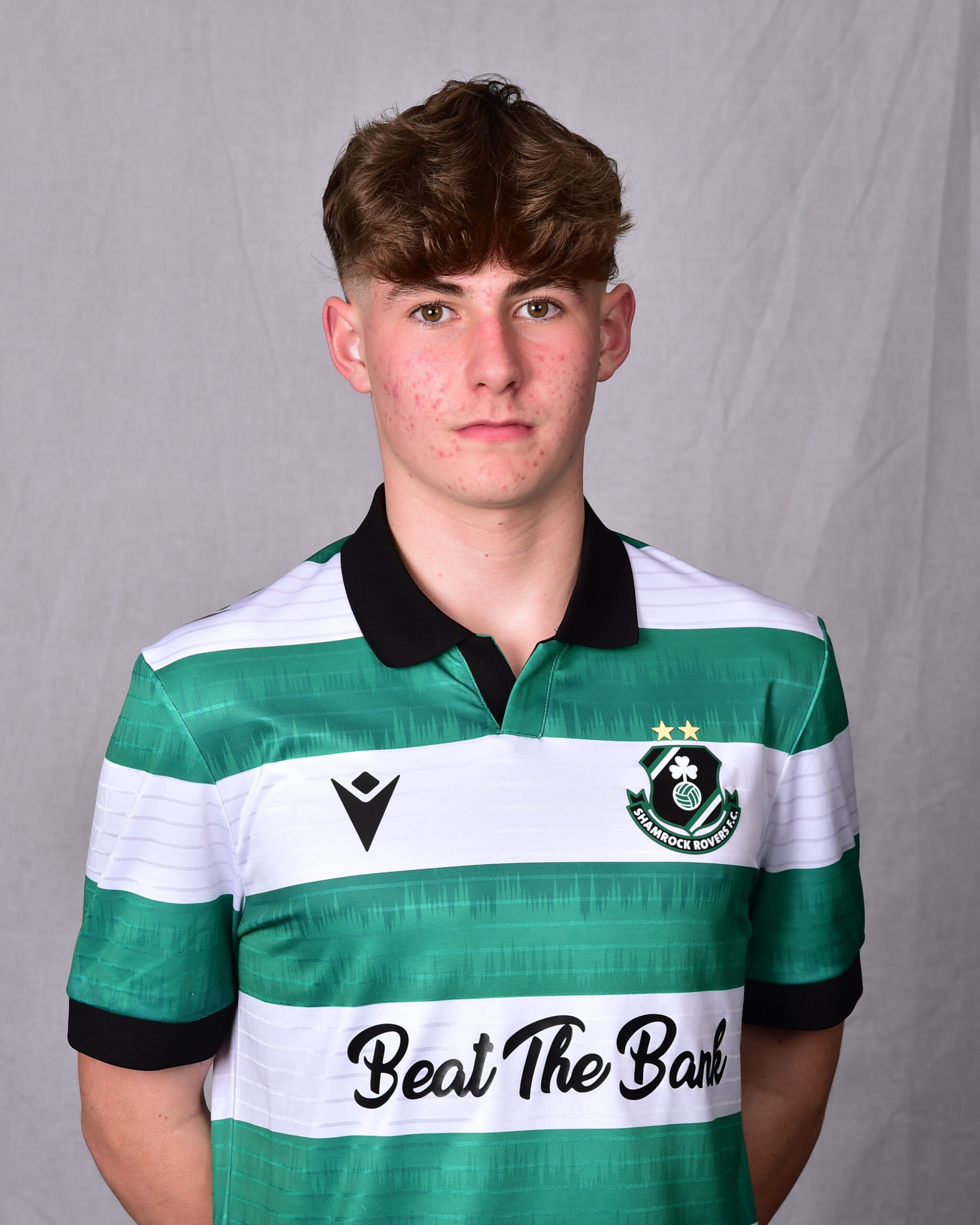 Young Shamrock Rovers player in green and white jersey, facing forward.