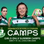 Shamrock Rovers girls soccer players at summer camp, holding jerseys and ball.