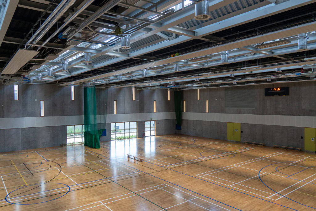 Indoor sports hall with wooden flooring and high ceiling at TU Dublin Tallaght Campus.