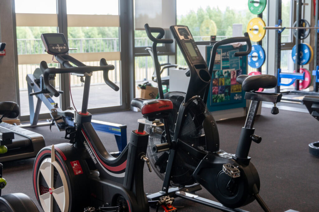 Indoor gym with exercise bikes and fitness equipment at TU Dublin Tallaght Campus.