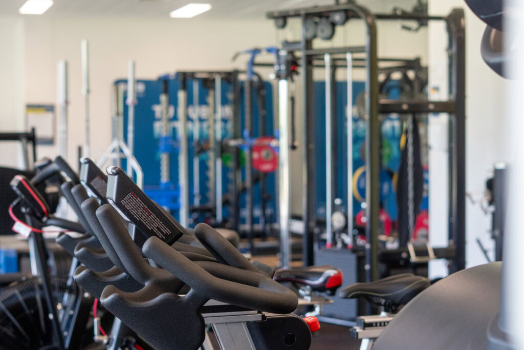 Indoor gym with exercise bikes and fitness equipment at SRFC Women’s Facility.