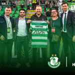 Group of five men at Shamrock Rovers stadium holding a 2026 Homefans jersey.